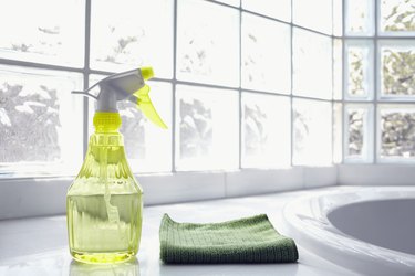 USA, New York State, New York City, Brooklyn, Cleaning supplies in front of glass brick wall