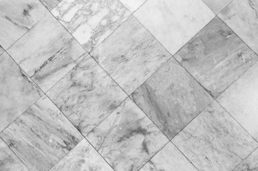 Close-up of a smooth marble floor viewed from above in black and white.