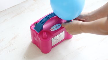 blowing up balloon with pump