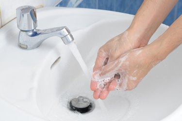 Close-Up Of Man Washing Hands In Sink