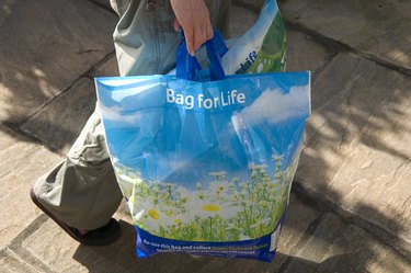 Woman carrying reusable plastic shopping bags