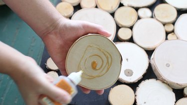 Applying wood glue to log slices