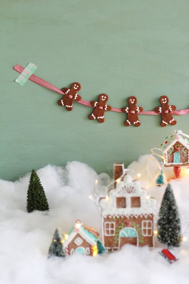 Gingerbread garland hanging above snowy gingerbread village
