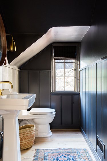 Powder room with dark walls and ceiling