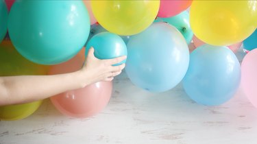 gluing smaller balloons to larger balloons