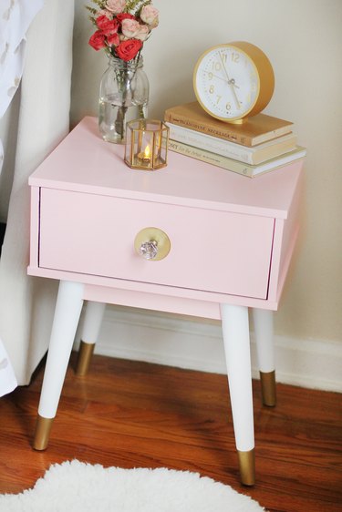 Nightstand painted blush pink with gold dipped legs