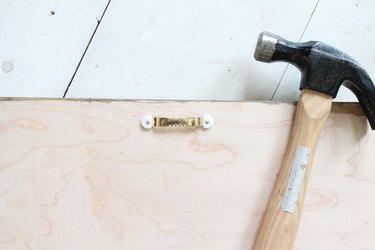 Add hangers to the back of the headboard