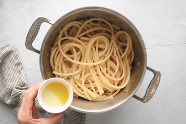 Toss pasta with olive oil
