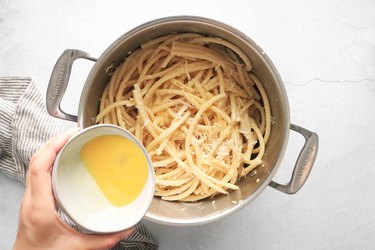 Add cheese and eggs to pasta