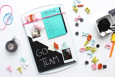cookie sheet memo board decorated with magnets, photos and notepads