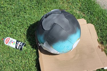 Paint the globe with black spray paint.