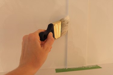 Painting the wall with a brush