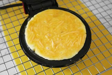 Add cheese-egg batter to waffle maker