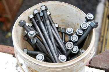 Close-up of bucket of nuts and bolts at construction site