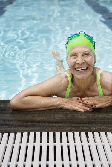 Smiling senior woman swimmer in pool