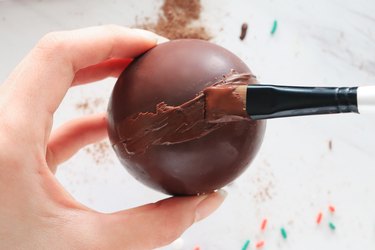 Seal each hot cocoa bomb with melted chocolate