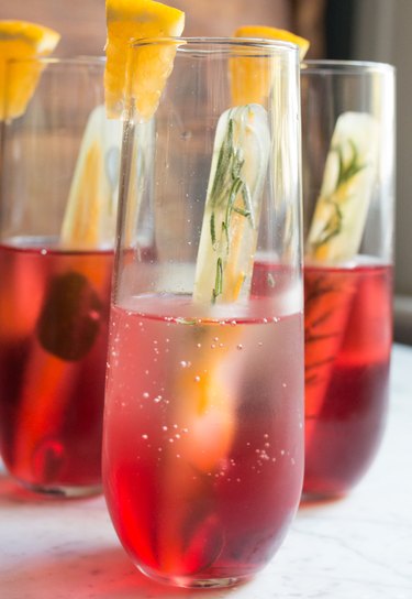 Rosemary and citrus ice cubes in a cranberry cocktail