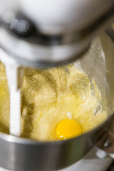 Stand mixer with butter, sugar, and eggs being mixed