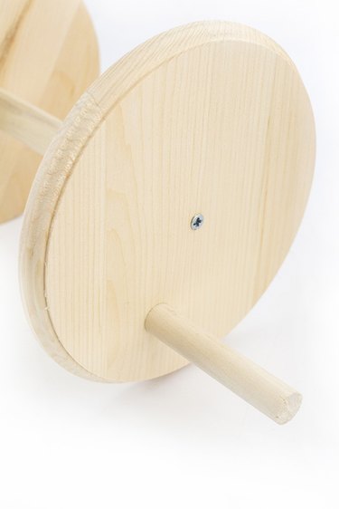 Attach wooden rod handles to the spool