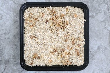 Toast quinoa, oats, and walnuts