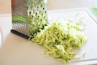 Grate the zucchini and then the cheese.