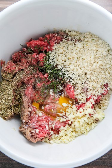 Combine the beef, garlic, egg, cheese, herbs, and bread crumbs.