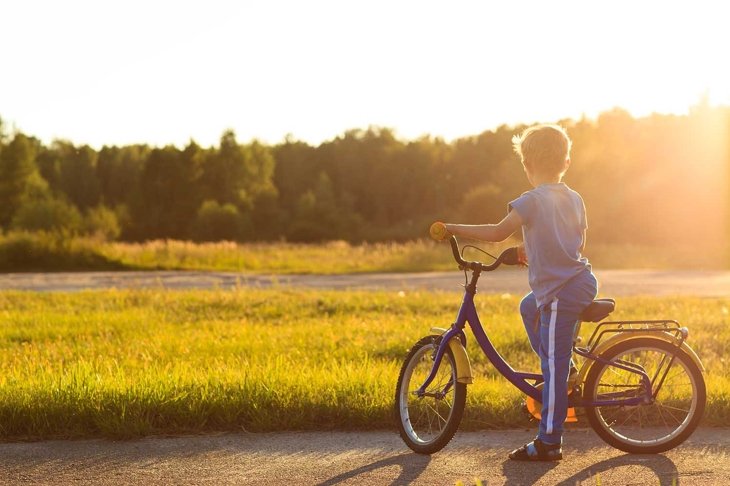 little boy riding bike at sunset, kids sport and  active lifestyle