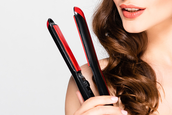 How to Curl Your Hair with a Flat Iron | Whether you have short, medium length, or long hair, learning how to curl hair with a flat iron is a game changer! We’re sharing our best tips, hair hacks, and products to teach you how to get perfect beach waves, tight curls, and everything in between. We’ve also included 3 step by step tutorials for beginners with quick, easy, and simple techniques for curls that last! #howtocurlhair #curlinghairflatiron #flatironcurls